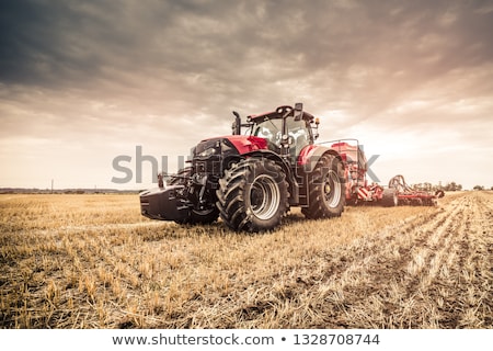 Foto stock: Tractor With Agricultural Machine On Land