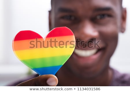 Foto d'archivio: Man With Gay Pride Rainbow And American Flag