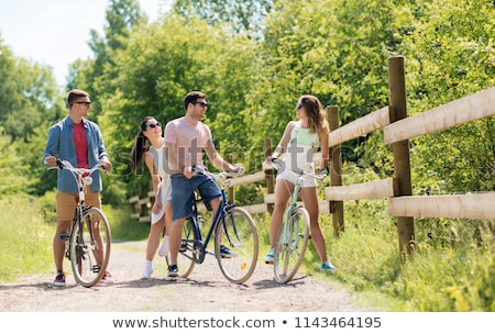 Foto stock: Happy Friends With Fixed Gear Bicycles In Summer