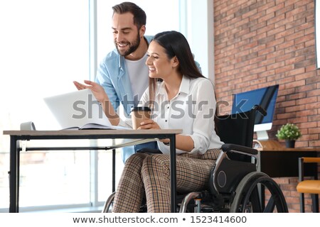 Сток-фото: Young Male Employee In Wheelchair Working In The Office