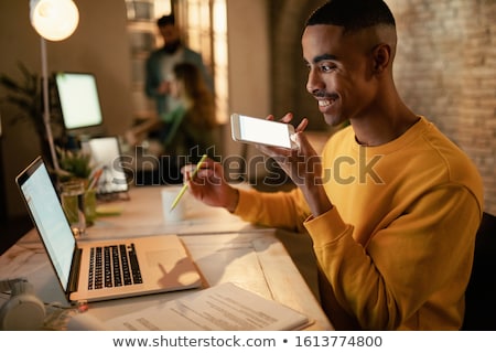 Stockfoto: Businessman Using Smart Speaker At Night Office