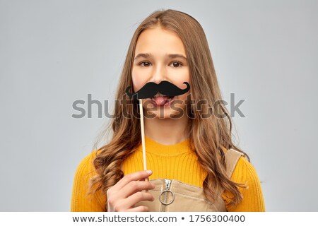 Foto d'archivio: Red Haired Teenage Girl With Black Moustaches