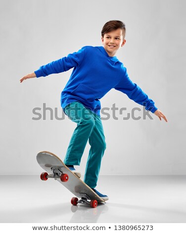 Stock fotó: Smiling Boy In Blue Hoodie With Skateboard