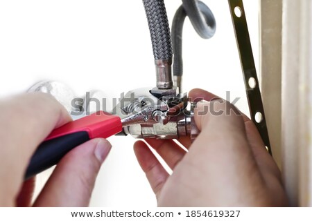 Stock photo: Adjustable Wrench Holding A Pipe Fixture