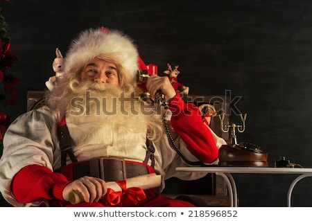 Stok fotoğraf: Portrait Of Emotional Santa Claus Calling Phone At Home