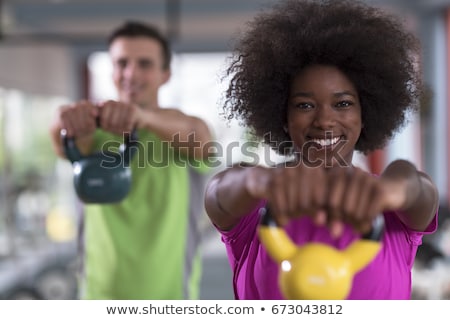 Foto d'archivio: Muscular Man Lifting A Kettlebell