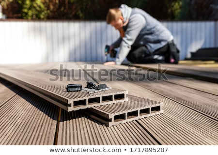 [[stock_photo]]: Brown Composite Decking Plank With Fixing Material