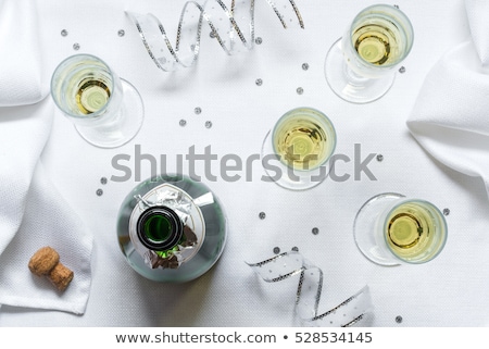 Foto stock: Champagne Bottle And Four Flutes On The Table