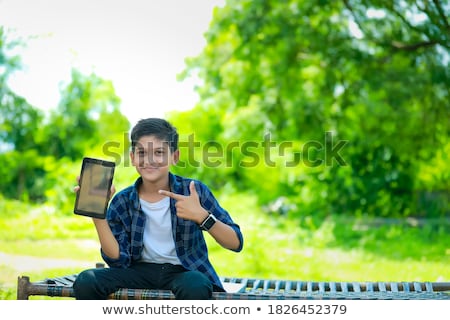 [[stock_photo]]: Ortrait · of · Smiling · Teenage · Boy · Holding · Mobile · Phone