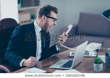 Сток-фото: Portrait Of An Angry Businessman Yelling At Phone