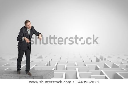 Foto stock: Sleepy Businessman On The Top Of A Labyrinth