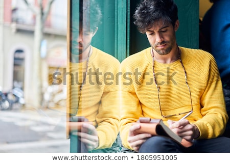 Stock foto: Man With Notebook Or Diary Writing On City Street