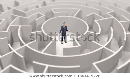 Stockfoto: Businessman Standing In A Middle Of A Round Maze