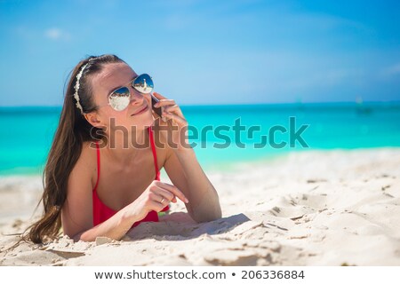 Stockfoto: Girl Sunbathing And Talking On The Phone