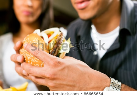 People In American Diner Or Restaurant Eating Fast Food Stockfoto © Kzenon