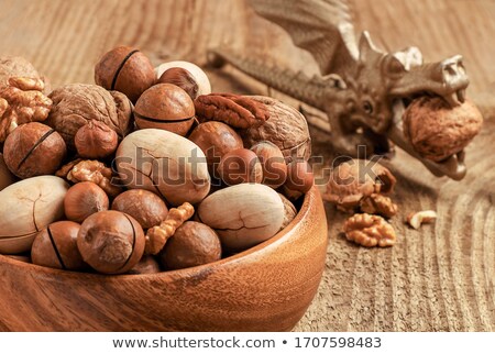 [[stock_photo]]: Various Nuts With Nut Tongs