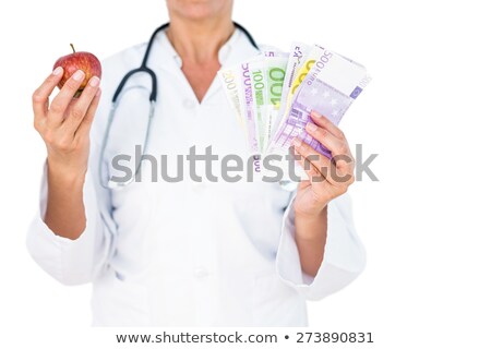 Foto stock: Part Of Professional Stethoscope On Euro Notes