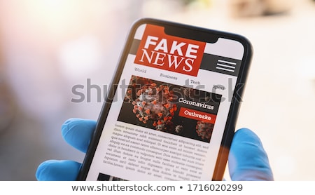 Foto stock: Man Reading Fake News On Newspaper