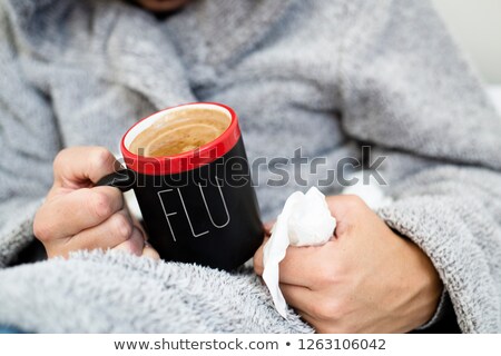 Stock fotó: Man With A Cup Of Coffee With The Word Flu In It