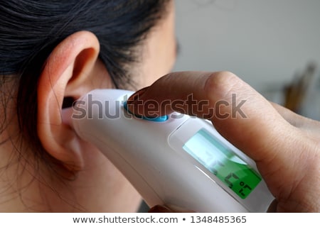 Stock fotó: Hand Checking Girls Ear With Digital Thermometer