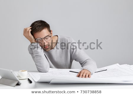 Foto stock: A Businessman Sleepy With Architectural Plans