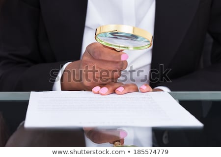 Stockfoto: Fraud Auditor Using Magnify Glass