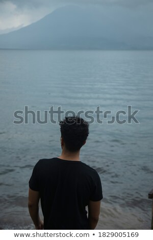 ストックフォト: Young Tourist Standing In Front Of A Lake
