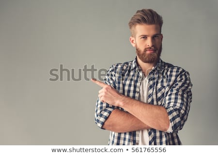 [[stock_photo]]: Smiling Casual Man Pointing Away