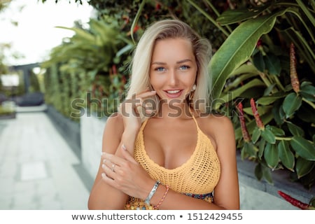 Stockfoto: Stylish Blond Young Girl Sitting On A Wooden Chest