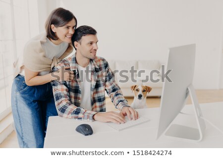 Stock fotó: Caring Young Happy Woman Leans At Husbands Shoulders Worries About Him Focused Into Computer Monit