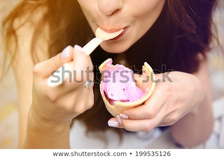 ストックフォト: Young Woman Eating Ice Cream Outside