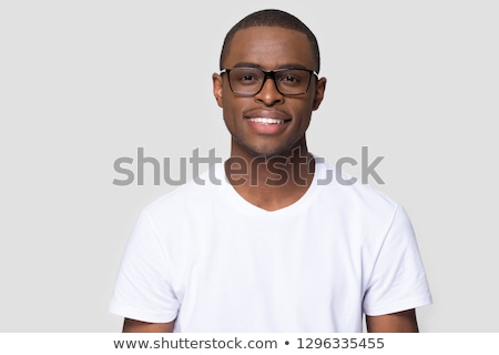 Stock photo: Smart Young Man Wearing Glasses Pose In Dark Studio