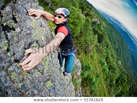 Stockfoto: Young White Man Climbing A Steep Wall In Mountain Rock Climb Ex
