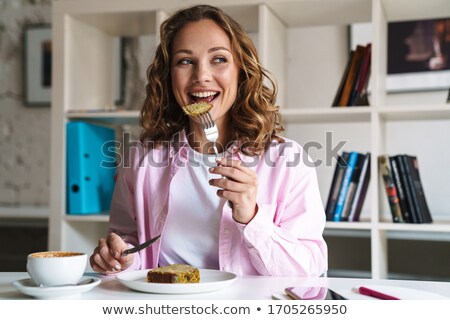 Stok fotoğraf: Nice Female In Cafe Eating Cake