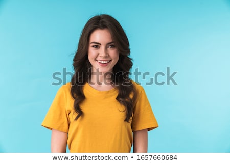 Stockfoto: Happy Pretty Woman Posing Isolated Over Blue Wall Background With Orange Citrus