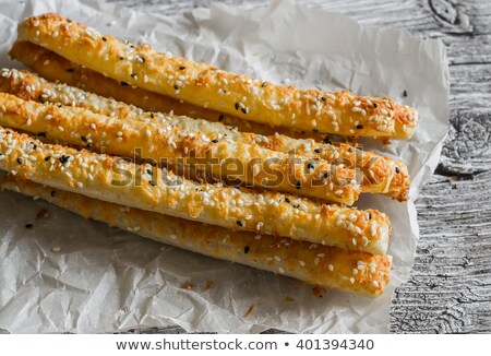 Foto stock: Italian Grissini Or Salted Bread Sticks With Sesame Seeds On Bla
