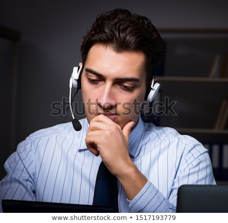 Foto stock: Call Center Operator Talking To Customer During Night Shift