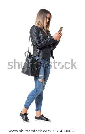 Stock photo: Pretty Young Woman Standing With Mobile Phone On Street At Autum