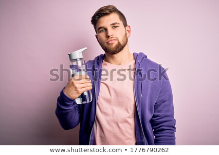 Stockfoto: Young Blonde Holding A Bottle