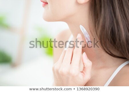 Stockfoto: Girl Applying Cream On Neck