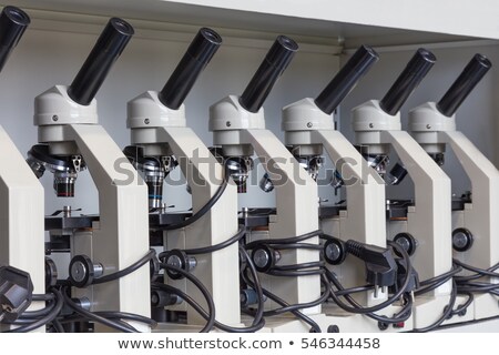 ストックフォト: Cabinet With Row Of Microscopes On Shelve At Biology