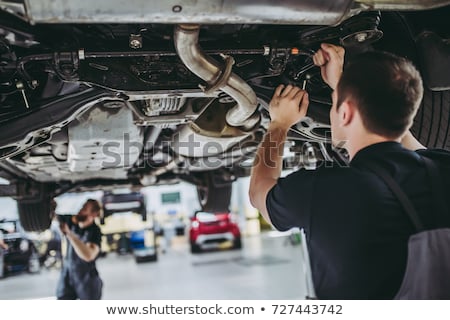 Stockfoto: Male Car Mechanic With Wheel