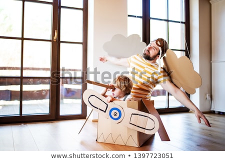 Foto stock: Happy Little Girl In Pilot Hat Playing At Home