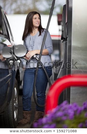 Stok fotoğraf: Woman Fills Petrol Into Her Car
