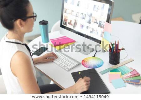 Foto stock: Casual Female Graphic Designer Using Smart Phone