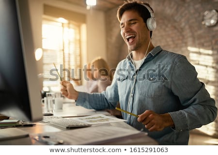 Stock photo: Young Caucasian Man Listening To Music