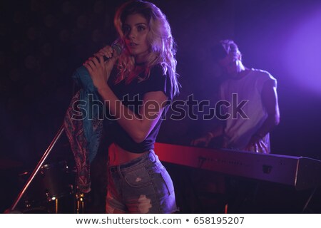 Stock fotó: Low Angle View Of Female Performer Playing Piano In Nightclub