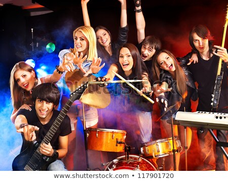 Foto stock: Male Musician Playing Piano In Illuminated Nightclub