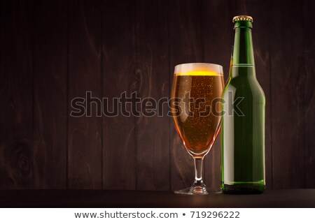 Stock foto: Green Beer Bottle And Glass Tulip With Golden Lager On Dark Brown Wood Board Copy Space Mock Up