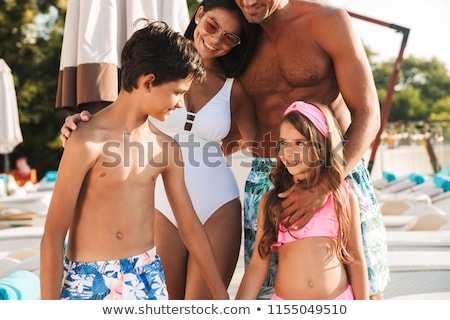 Stock fotó: Photo Of Happy Family With Kids Resting Near Luxury Swimming Poo